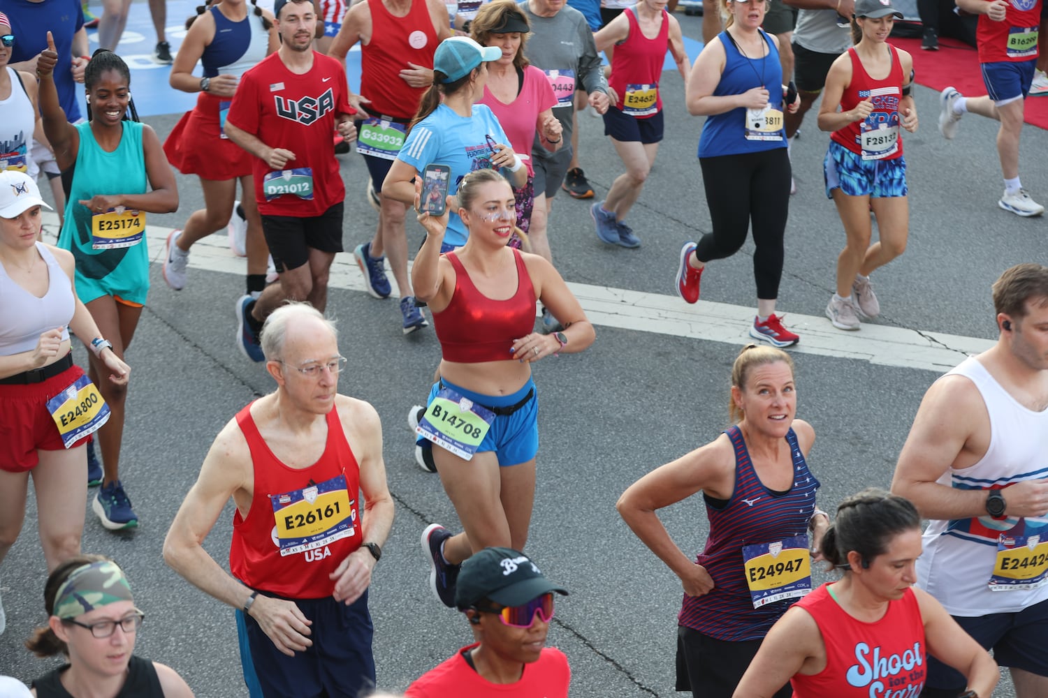 Runners show excitement at the start of the 56th AJC Peachtree Road Race on Friday, July 4, 2025, in Atlanta. (Arvin Temkar/AJC)