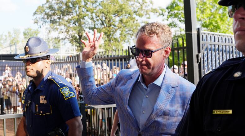 LSU football coach Lane Kiffin waves to fans as he enters the Vaught-Hemingway Stadium prior to an NCAA college football game against Mississippi in Oxford, Miss., Saturday, Sept. 19, 2026. (AP Photo/Rogelio V. Solis)