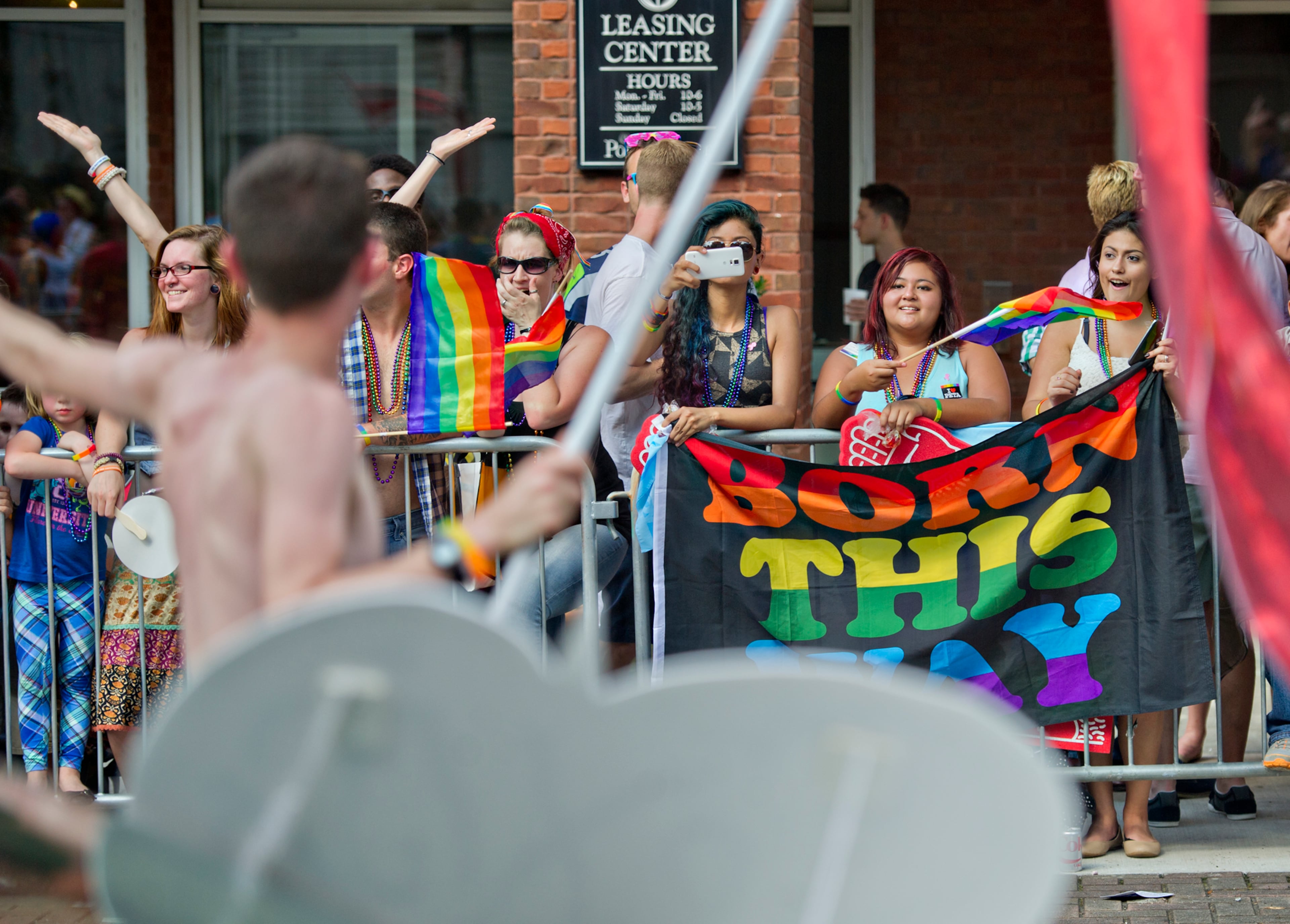 Estefani Maldonado (right), Bernice Maldonado and Nadia Hernandez watch the Atlanta Pride Parade pass by on 10th St. on Sunday, October 12, 2014. JONATHAN PHILLIPS / SPECIAL