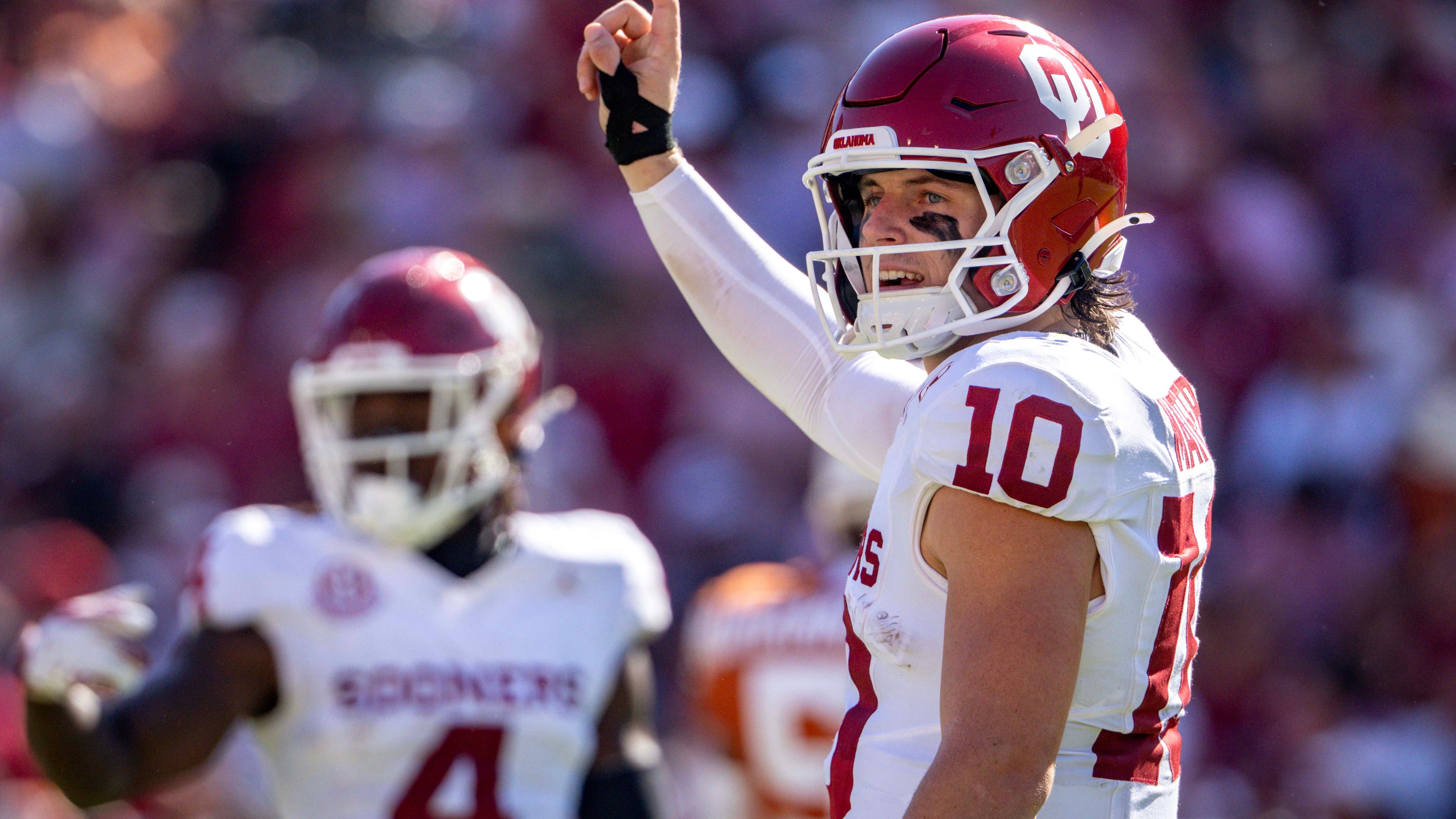 Oklahoma quarterback John Mateer signals to the sideline during the first half of an NCAA college football game against Texas, Saturday, Oct. 11, 2025, in Dallas. (AP Photo/Jeffrey McWhorter)
