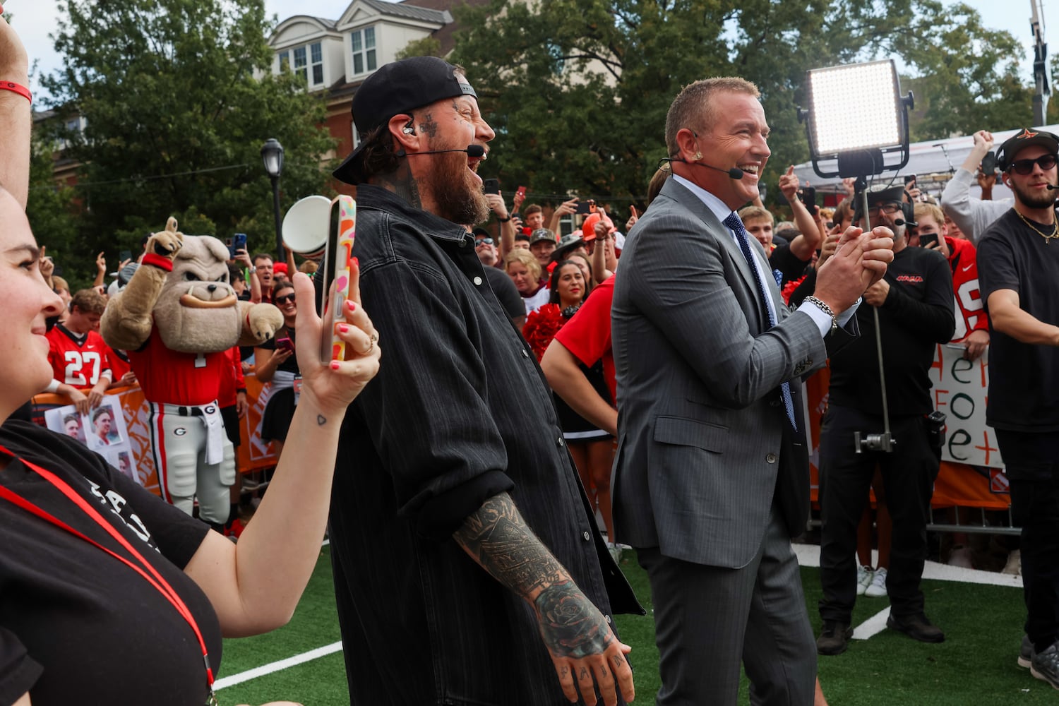Singer-songwriter Jelly Roll (left) and analyst Kirk Herbstreit celebrate during the Pat McAfee kicking contest on the ESPN College GameDay broadcast from Myers Quad at UGA on Saturday, Oct. 18, 2025. Jelly Roll is the week’s celebrity guest picker. (C.J. Bartunek for the AJC)
