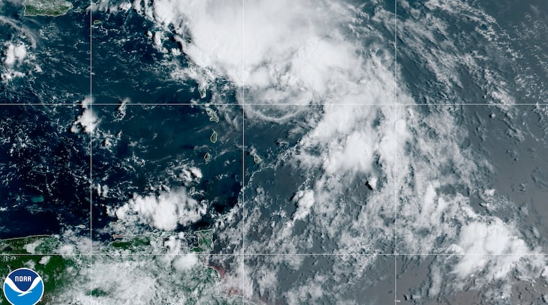 This satellite image released by the National Oceanic and Atmospheric Administration (NOAA) shows Tropical Storm Laura in the North Atlantic Ocean, Friday, Aug. 21, 2020. Laura formed Friday in the eastern Caribbean and forecasters said it poses a potential hurricane threat to Florida and the U.S. Gulf Coast. A second storm also may hit the U.S. after running into Mexico's Yucatan Peninsula.