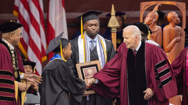 President Biden shakes hands with salutatorian Dwayne Allen Terrell II, left, at the commencement ceremony on May 19 at Morehouse College in Atlanta. (Arvin Temkar/The Atlanta Journal-Constitution)