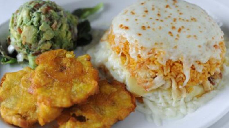 Mojitos Cuban-American Bistro's stuffed rice casserole is layered with breaded chicken, yellow rice and mozzarella and Parmesan cheese. It's served with avocado salad and tostones.