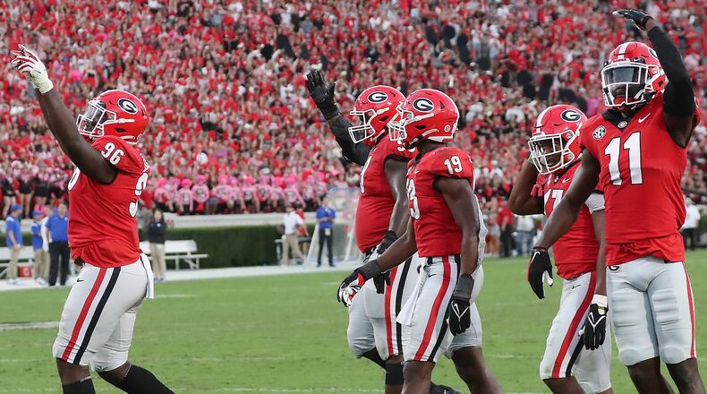 Georgia defenders begin to celebrate with 3 seconds left in the 30-13 victory over Kentucky Saturday, Oct. 16, 2021, at Sanford Stadium in Athens. (Curtis Compton / Curtis.Compton@ajc.com)