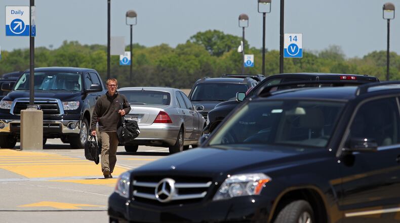 A traveler walks toward the north terminal from the parking deck at Hartsfield-Jackson Atlanta International Airport. JASON GETZ