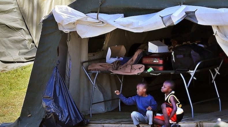 Children sit together at the border migrant camp at St. Bernard de Lacolle. Among the migrants are Haitians who worry that their Temporary Protected Status in the U.S. could soon end under the Trump administration. (Al Diaz/Miami Herald/TNS)