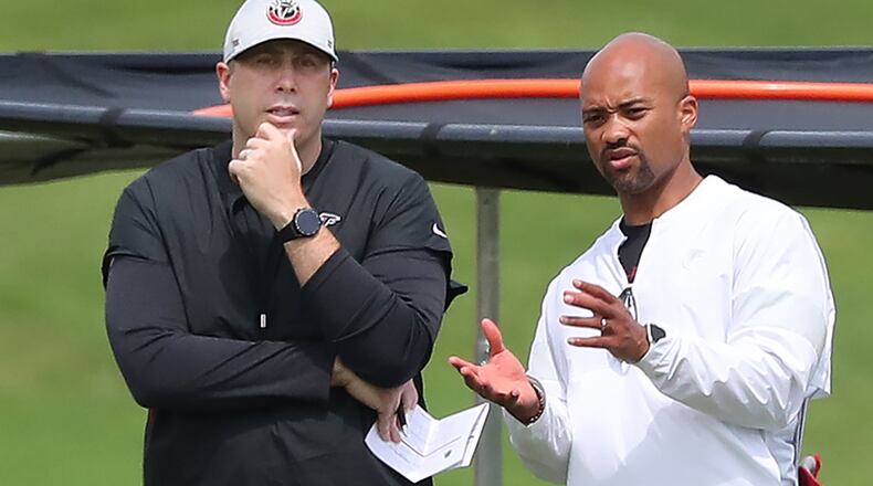 Falcons head coach Arthur Smith (left) and general manager Terry Fontenot (right) confer during team practice at mini-camp on Wednesday, Jun 10, 2021, in Flowery Branch.