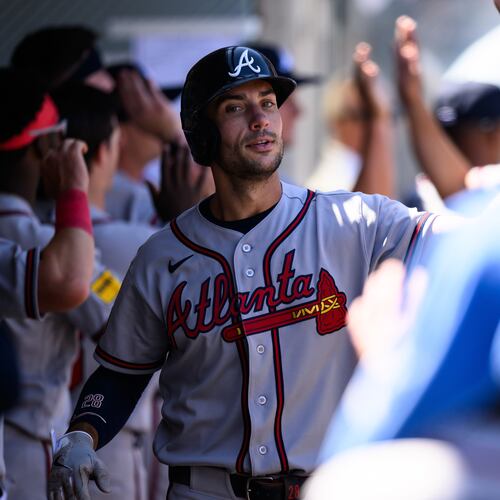 Atlanta Braves first baseman Matt Olson is greeted by teammates after scoring during the third inning of a baseball game against the Los Angeles Angels, Wednesday, April 8, 2026, in Anaheim, Calif. (AP Photo/William Liang)