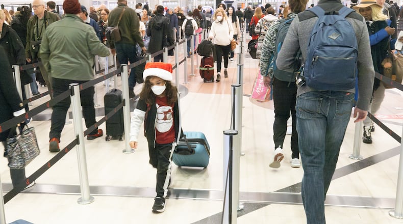 Travelers make their way to security at Hartsfield-Jackson Atlanta International Airport on Friday, which is expected to be the peak day for Christmas holiday travel (Steve Schaefer/steve.schaefer@ajc.com)