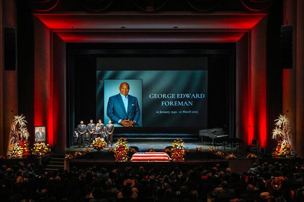 George Foreman IV stands with his brothers as he says the eulogy for his father during a memorial service for Olympic and world champion boxer and minister George Foreman at Wortham Theater Center in Houston, Monday, April 14, 2025. (Brett Coomer/Houston Chronicle via AP)