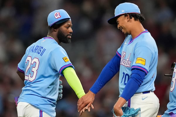 Braves center fielder Michael Harris II (left) and pitcher Osvaldo Bido celebrate a win over the Cleveland Guardians on Friday, April 10, 2026, in Atlanta. (Mike Stewart/AP)