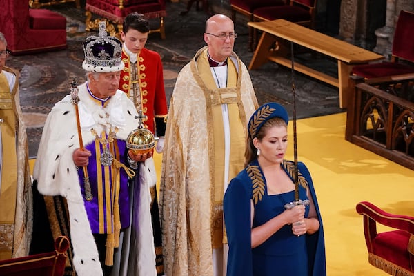 FILE - Lord President of the Council, Penny Mordaunt, holds the Sword of State walking ahead of King Charles III during his coronation ceremony in Westminster Abbey, London, Saturday May 6, 2023. (Yui Mok, Pool via AP, file)