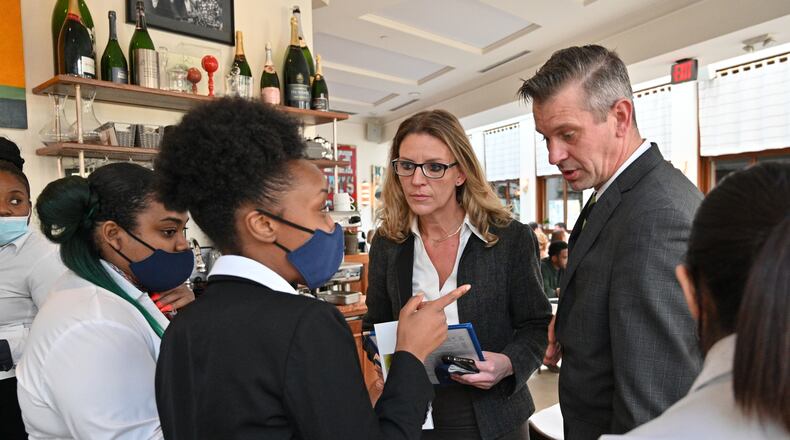 Ilona Knopfler, center, and Chad Goughnour, service director, listen to restaurant employees at Le Bilboquet, where she works as a consultant, in Buckhead on Thursday, November 11, 2021. Knopfler quit her job in May of this year, took a few months off, sang at a jazz festival in Pennsylvania, then became an industry consultant. (Hyosub Shin / Hyosub.Shin@ajc.com)