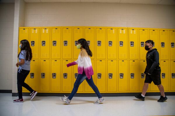 Masks are option in the Cobb County School District, but these students opted to wear them during the first day of school at Pearson Middle School in Marietta on Aug. 2, 2021. The district reported 185 cases of COVID-19 during the first week, but none at Pearson Middle School.(Alyssa Pointer/Atlanta Journal Constitution)