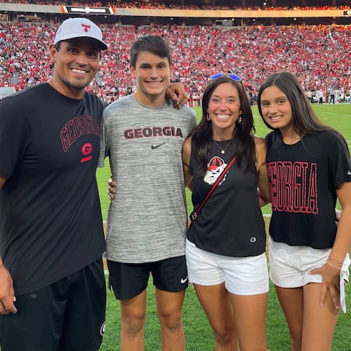 Bulldogs great and College Football Hall of Famer David Pollack (left), shown here with his family along the sidelines of Sanford Stadium during a UGA home game, was a standout defensive player for Georgia from 2001 through 2004. (Courtesy of the Pollack family from UGA Athletics)