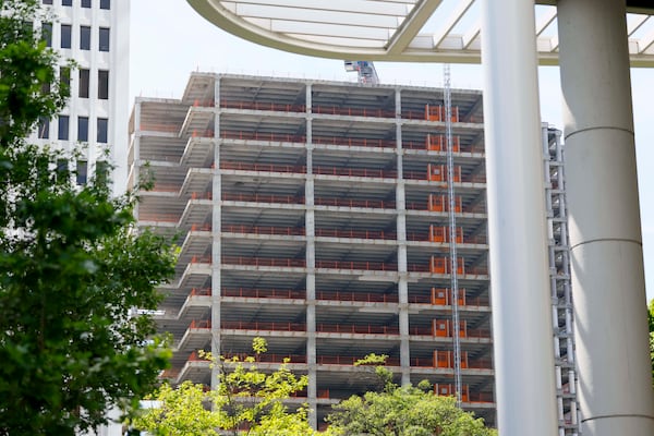 A section of the Campanile building can be seen from Peachtree Street NE and 14th Street on Tuesday, May 19, 2026. Dewberry Capital purchased the building in 2010, but little visible progress has been made since renovation began more than five years ago. (Miguel Martinez/AJC)