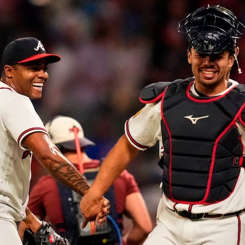 Atlanta Braves pitcher Raisel Iglesias celebrates a win over the Chicago Cubs with Drake Baldwin after a baseball game, Wednesday, May 13, 2026, in Atlanta. (AP Photo/Mike Stewart)