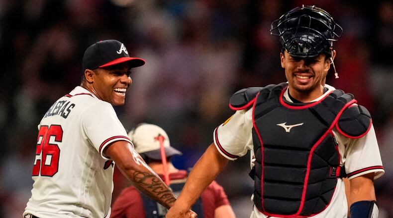 Atlanta Braves pitcher Raisel Iglesias celebrates a win over the Chicago Cubs with Drake Baldwin after a baseball game, Wednesday, May 13, 2026, in Atlanta. (AP Photo/Mike Stewart)