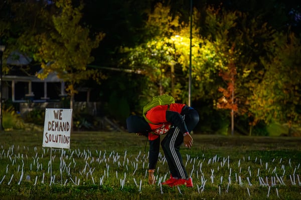 Protesters plant 460 forks outside the closed Atlanta Medical Center on the first anniversary of it's closing. (Jamie Spaar for the AJC 2023)