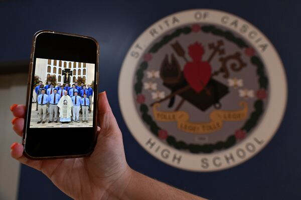 A photo of the new Pope Leo XIV, Chicago native Cardinal Robert Prevost is shown on a phone from when he was a substitute teacher at St. Rita high school Thursday, May 8, 2025, in Chicago. (AP Photo/Paul Beaty)
