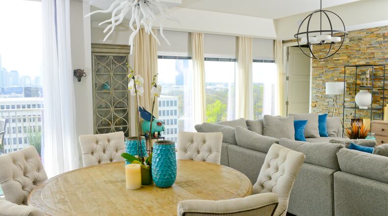 Jeffrey Taylor Johnson's Atlanta dining room serves up dinner and a spectacular view whenever guests gather. The 1,834-square-foot high-rise condo has an open floor plan, which meant Johnson's furnishings needed a cohesive style. The round table and six chairs, all from RH, are consistent with the transitional interior design throughout the unit.