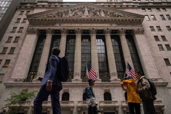 People walk past the New York Stock Exchange, Wednesday, June 18, 2025, in New York. (AP Photo/Yuki Iwamura)