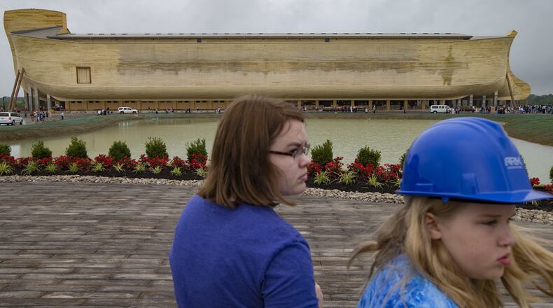 Visitors roam the Ark Encounter theme park as a replica of Noah’s Ark stands in the distance during a media preview day, Tuesday, July 5, 2016, in Williamstown, Ky. The long-awaited theme park based on the story of a man who got a warning from God about a worldwide flood will debut in central Kentucky this Thursday. The Christian group behind the 510 foot-long wooden ark says it will demonstrate that the stories of the Bible are true. Its construction has rankled opponents who say the attraction will be detrimental to science education. (AP Photo/John Minchillo)