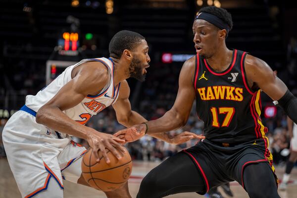 Atlanta Hawks forward Onyeka Okongwu (17), right, guards New York Knicks forward Mikal Bridges during the first half Saturday, April 5, 2025, in Atlanta. (AP Photo/Erik Rank)