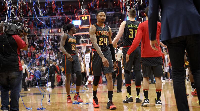 Atlanta Hawks forward Kent Bazemore (24) and forward Taurean Prince (12) walk off the court after Game 2 of the team’s first-round NBA basketball playoff series against the Washington Wizards, Wednesday, April 19, 2017, in Washington. The Wizards won 109-101. (AP Photo/Nick Wass)