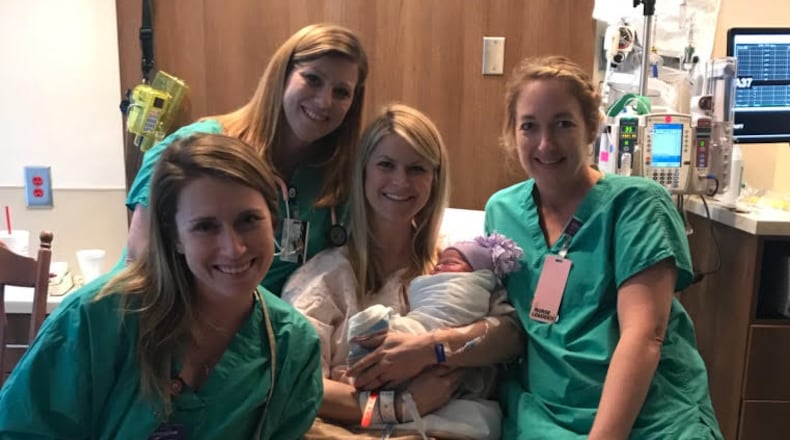 Nurse Kinsey Close (center) with her nursing colleagues after delivering her third child.