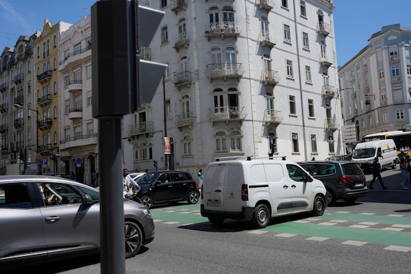 Motorists drive past traffic lights that stopped working following a power outage in downtown Lisbon, Portugal, Monday, April 28, 2025. (AP Photo/Armando Franca)