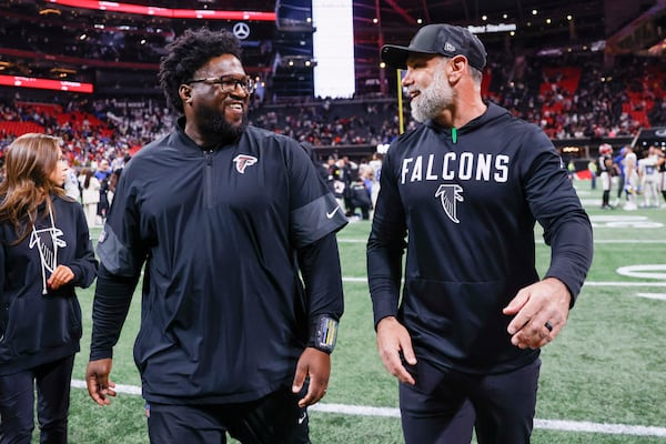 Jeff Ulbrich (right), shown walking off the field at Mercedes-Benz Stadium with defensive line coach Nate Ollie, led the Falcons’ defense to a significant leap last fall. (Miguel Martinez/AJC 2025)