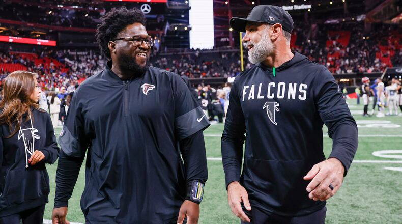 Jeff Ulbrich, Atlanta Falcons defensive coordinator, right, walks off the field with Atlanta Falcons defensive line coach Nate Ollie after the Falcons beat the Los Angeles Rams 27-24 at Mercedes-Benz Stadium on Monday, Dec. 29, 2025. (Miguel Martinez/AJC)