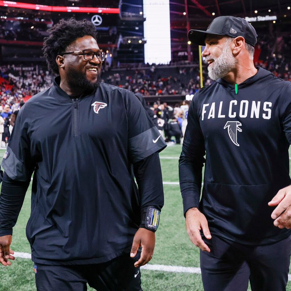 Falcons defensive line coach Nate Ollie (left, with defensive coordinator Jeff Ulbrich) uses an intense and vocal approach with his players. (Miguel Martinez/AJC 2025)