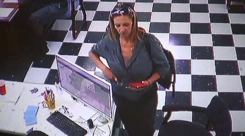 A woman seen on surveillance video is suspected of stealing a minivan from a Hall County dealership. (Credit: Kar Kingdom)