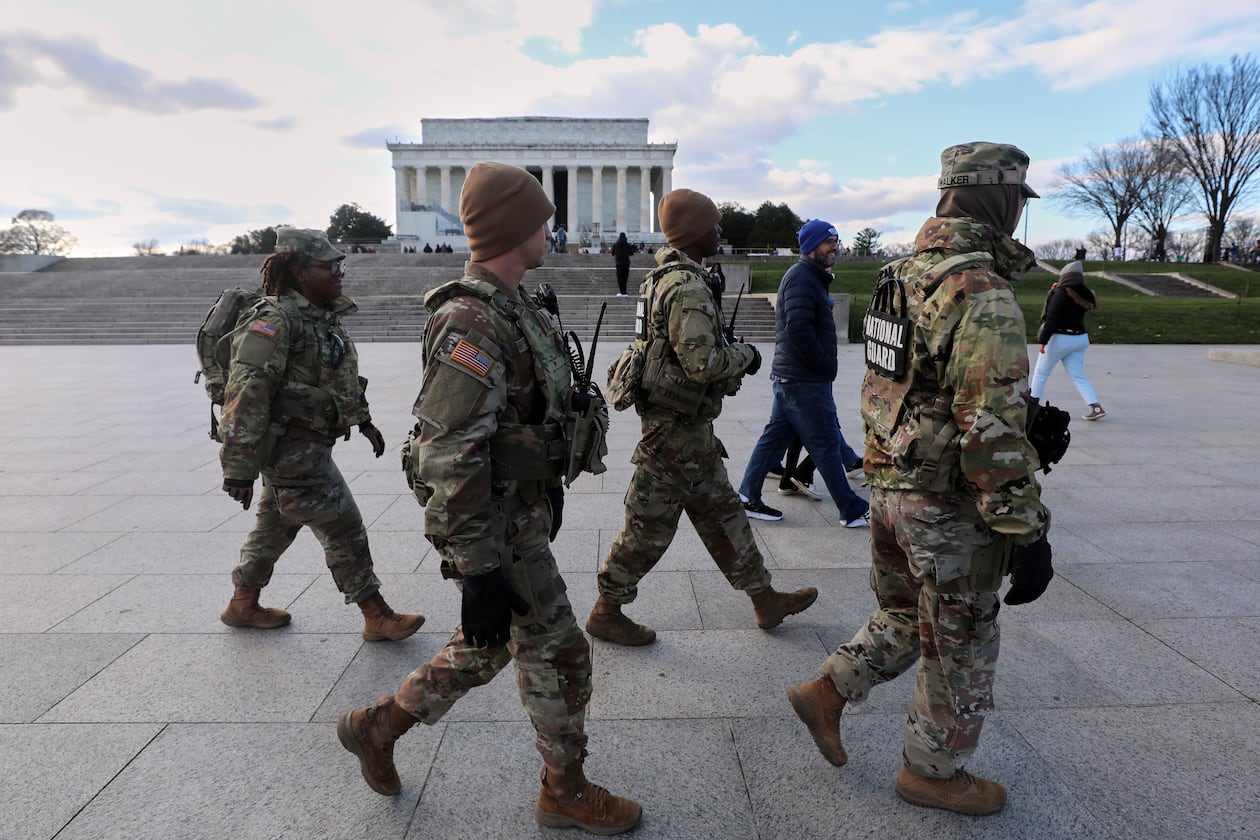 National Guard patrol the National Mall near the Lincoln Memorial, Friday, Nov. 28, 2025, in Washington. (AP Photo/Rahmat Gul)