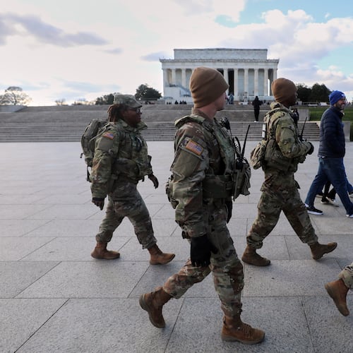 National Guard patrol the National Mall near the Lincoln Memorial, Friday, Nov. 28, 2025, in Washington. (AP Photo/Rahmat Gul)
