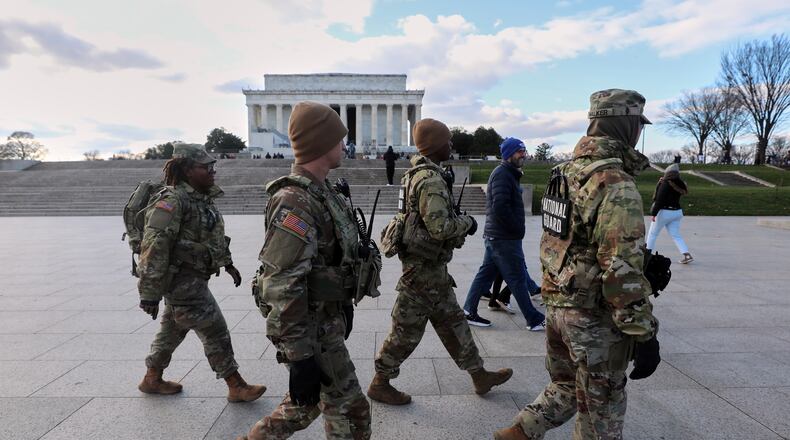 National Guard patrol the National Mall near the Lincoln Memorial, Friday, Nov. 28, 2025, in Washington. (AP Photo/Rahmat Gul)