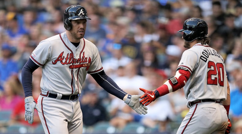 Freddie Freeman #5 and Josh Donaldson #20 of the Atlanta Braves celebrate after Freeman hit a home run in the fourth inning against the Milwaukee Brewers at Miller Park on July 15, 2019 in Milwaukee, Wisconsin. (Photo by Dylan Buell/Getty Images)