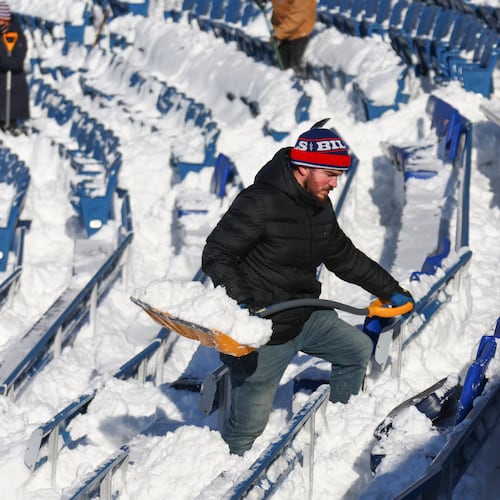 FILE - A stadium worker clears snow from seats before an NFL wild-card playoff football game between the Buffalo Bills and the Pittsburgh Steelers, Jan. 15, 2024, in Buffalo, N.Y. (AP Photo/Jeffrey T. Barnes, File)