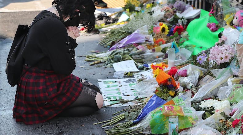 061520 Atlanta: A woman (who declined to be identified) pays her respects at the Atlanta Wendy’s where Rayshard Brooks, a 27-year-old black man, was shot and killed by Atlanta police Friday evening during a struggle in the drive-thru line on Monday, June 15, 2020, in Atlanta. Curtis Compton ccompton@ajc.com