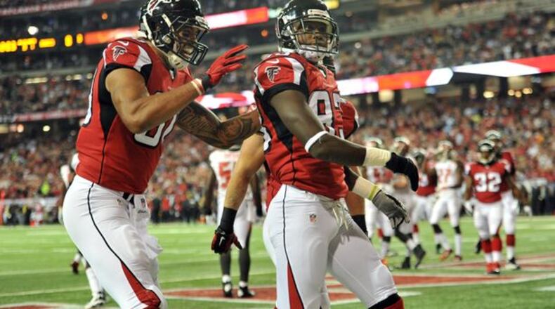 Atlanta Falcons wide receiver Harry Douglas (83) is celebrated by Atlanta Falcons tight end Levine Toilolo (80) after he scored a touchdown against the Tampa Bay Buccaneers in the first half during the first half in their NFL football game on Thursday, September 18, 2014. HYOSUB SHIN / HSHIN@AJC.COM