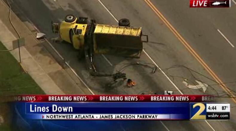 This yellow truck appears to have hit and downed power lines at Bolton Road and James Jackson Parkway on Thursday afternoon, authorities said.