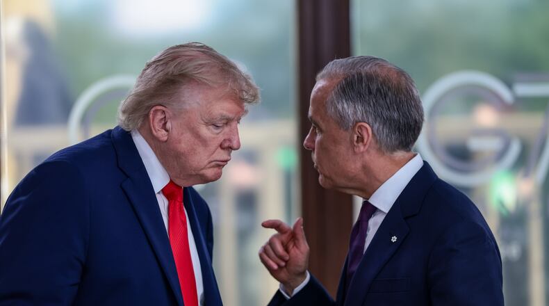 FILE - President Donald Trump speaks with Canadian Prime Minister Mark Carney, right, at a working lunch with leaders of G7 and the Middle East in Evian-les-Bains, France, Tuesday, June 16, 2026. (Evelyn Hockstein/Pool Photo via AP,File)