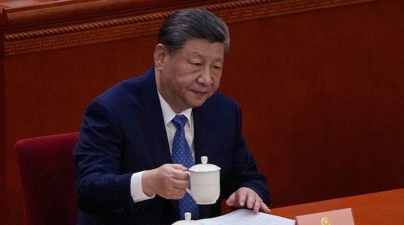 Chinese President Xi Jinping holds his cup of tea during the opening of the Chinese People's Political Consultative Conference at the Great Hall of the People, in Beijing, China, Wednesday, March 4, 2026. (AP Photo/Andy Wong)