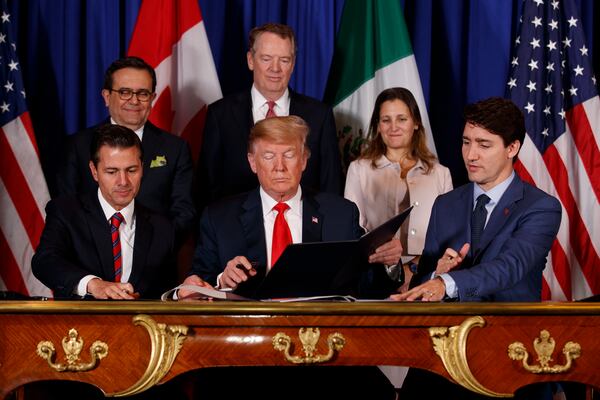 Then-President Enrique Peña Nieto of Mexico (from left), U.S. President Donald Trump and then-Prime Minister Justin Trudeau of Canada sign the United States-Mexico-Canada Agreement on the sidelines of the G-20 summit in Buenos Aires, Argentina, on Friday, Nov. 30, 2018. (Tom Brenner/NYT)