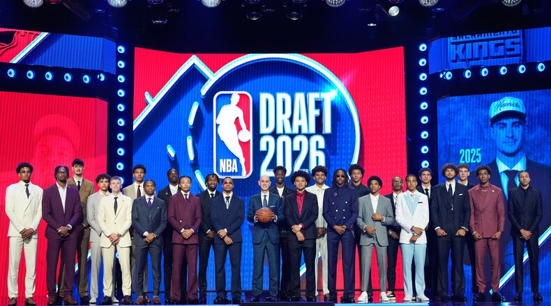 Prospective draftees pose for a group photo with NBA Commissioner Adam Silver, center, before the first round of the NBA basketball draft, Tuesday, June 23, 2026, in New York. (AP Photo/Yuki Iwamura)