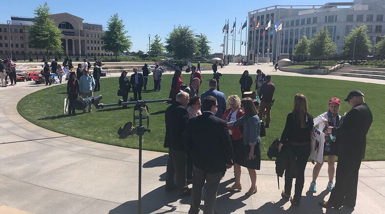 People gather at Liberty Plaza, near the state Capitol, for a rally Monday marking the 10th anniversary of the tea party’s first major demonstration in Atlanta. That first one drew thousands of conservatives, but Monday’s event, organized by Ralph Reed of the Faith and Freedom Coalition, attracted fewer than 50. (Photo by Greg Bluestein)