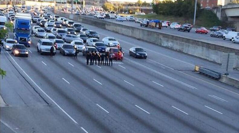 Protesters stand in the middle of I-75 northbound near Freedom Parkway. (Shelby Messing)